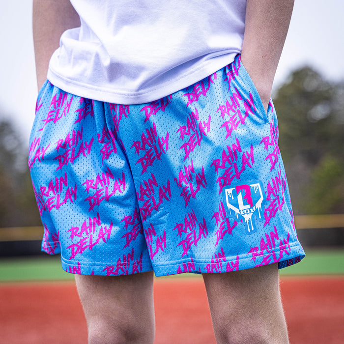Youth model wearing blue Rain Delay Cotton Candy youth shorts