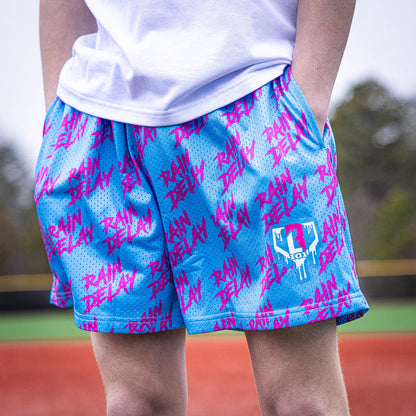 Youth model wearing blue Rain Delay Cotton Candy youth shorts