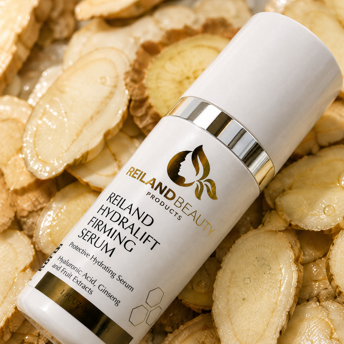 Reiland Beauty Products HydraLift Firming Serum bottle displayed on dewy snow mushroom slices, highlighting hyaluronic acid, ginseng, and fruit extracts for hydrating, firmer-looking skin.