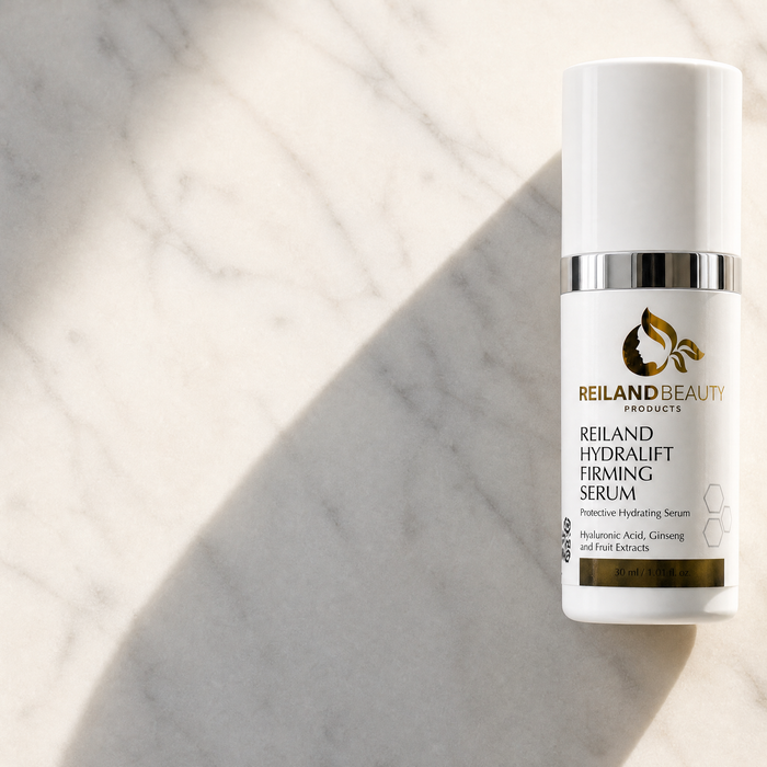 Reiland Beauty Products HydraLift Firming Serum standing on a sunlit marble surface, featuring hyaluronic acid, ginseng, and fruit extracts.