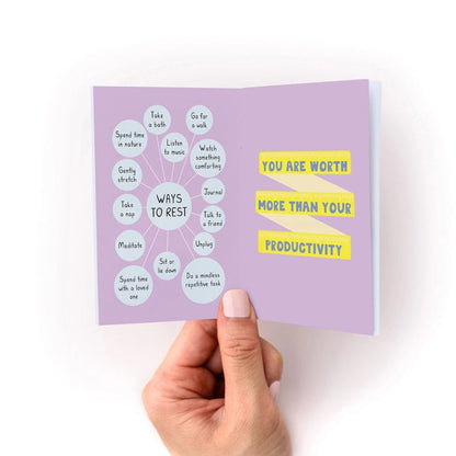 Opened purple zine with multiple labeled sections and yellow quote and productivity stickers