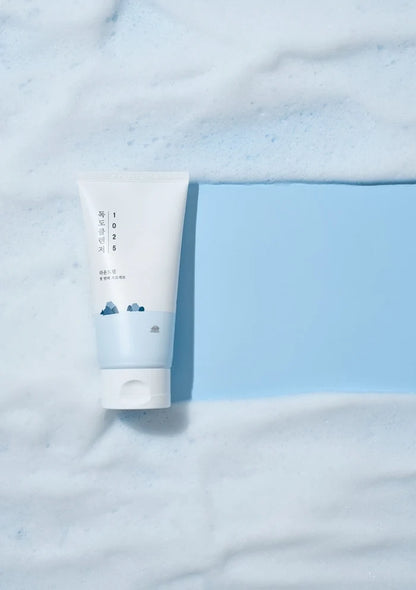 Tube of cream on a light blue fabric background