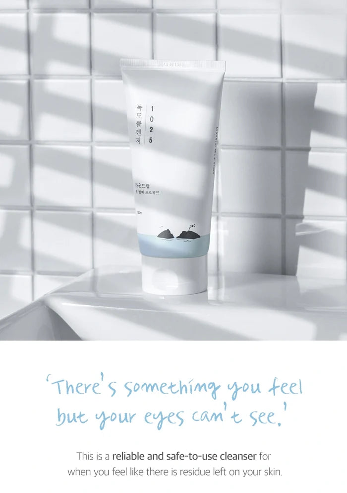 Cleanser tube on a white tiled wall with text overlay