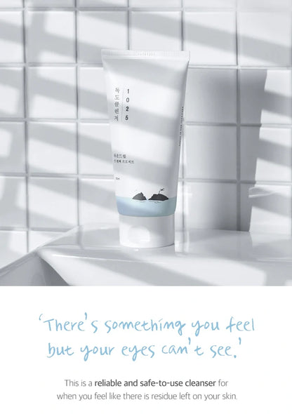Cleanser tube on a white tiled wall with text overlay