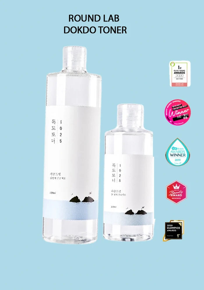 Two bottles of Round Lab Dokdo Toner on a light blue background with certification logos.