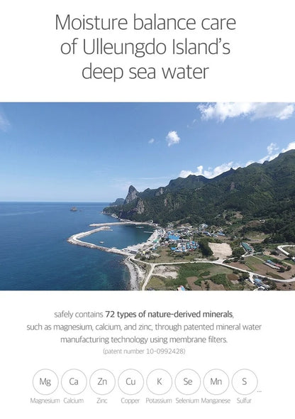 Scenic view of a coastal area with mountains and clear blue sky, promoting moisture balance care from Ulleungdo Island's deep sea water.