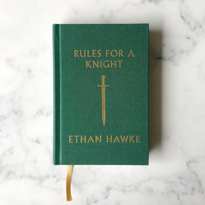 Green hardcover book with gold title text, sword emblem, and fabric bookmark ribbon