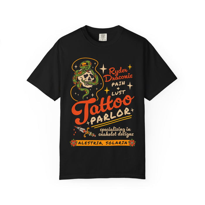 thtgrlreads Ruthless Boys of the Zodiac collection Comfort Colors graphic tee featuring a vintage-style tattoo parlor design with bold orange and cream text on a black unisex cotton shirt.