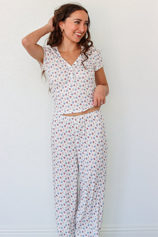 Woman wearing a short sleeve top and pant PJ set with seashell prints