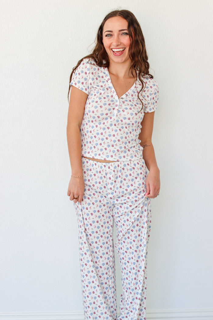 Woman wearing a short sleeve top and pant PJ set with seashell prints