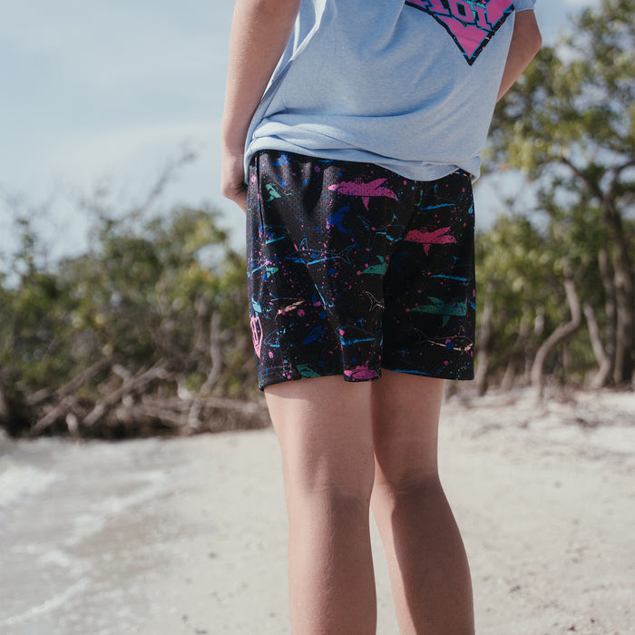 Adult model wearing black shorts with “Shark” design