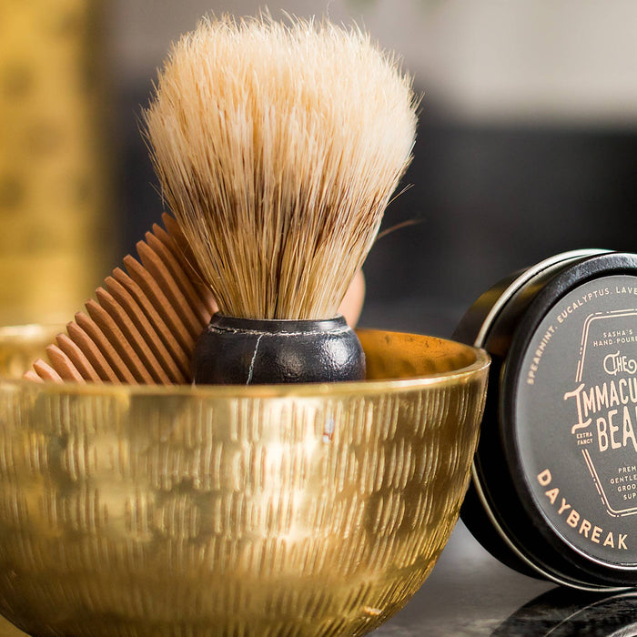 The Immaculate Beard shaving brush with wooden handle and soft bristles for a smooth shave.