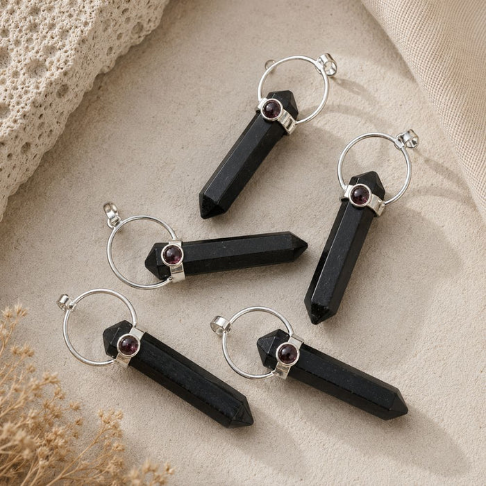 Shungite point pendant with Garnet accent on a silver bail and chain.