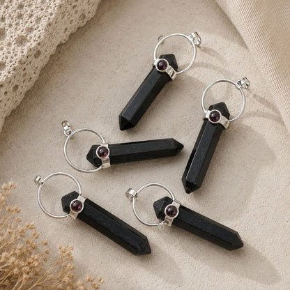 Shungite point pendant with Garnet accent on a silver bail and chain.