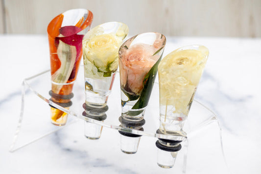 Landscape photo of a pressed flower wine stopper with soft dried roses in a home setting