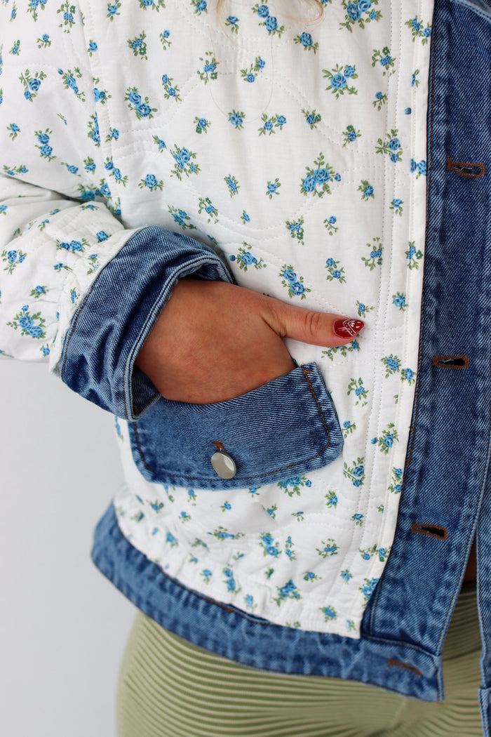 Close up of a floral denim jacket with pockets