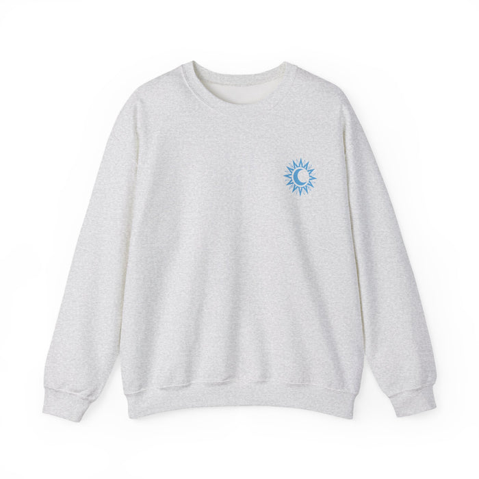 A cozy vintage-washed Comfort Colors crewneck sweatshirt from thtgrlreads featuring a small blue sun and crescent moon graphic, part of the Kindred's Curse Saga collection by Printify.