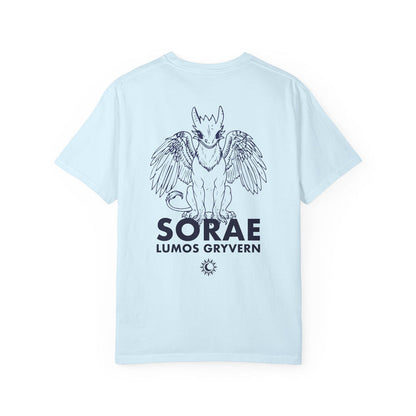 The thtgrlreads Kindred's Curse Saga Comfort Colors graphic tee features a light blue 100% ring-spun cotton base with a black line art print of a winged gryvern and bold text, officially licensed by Penn Cole and available through Printify in the Tees collection.