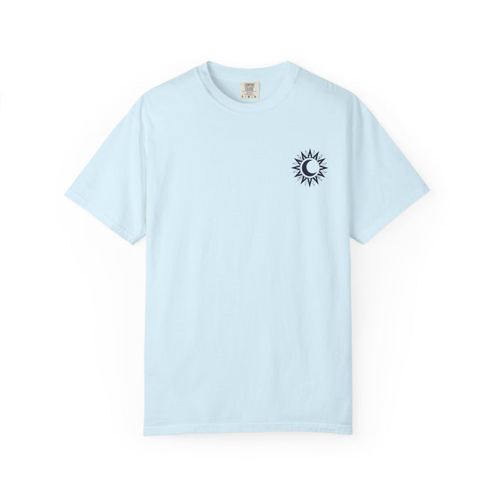 A light blue Comfort Colors graphic tee from thtgrlreads featuring a small black sun and crescent moon design inspired by the Kindred's Curse Saga by Penn Cole, available through Printify in the Tees collection.