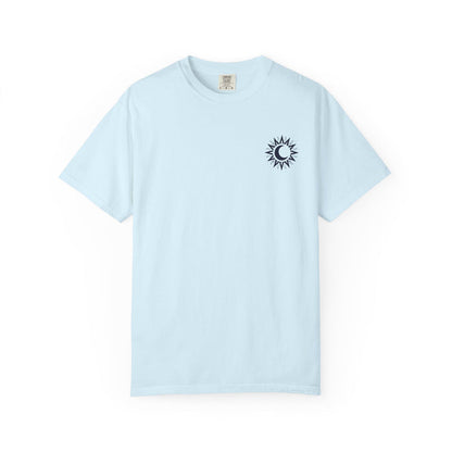 A light blue Comfort Colors graphic tee from thtgrlreads featuring a small black sun and crescent moon design inspired by the Kindred's Curse Saga by Penn Cole, available through Printify in the Tees collection.