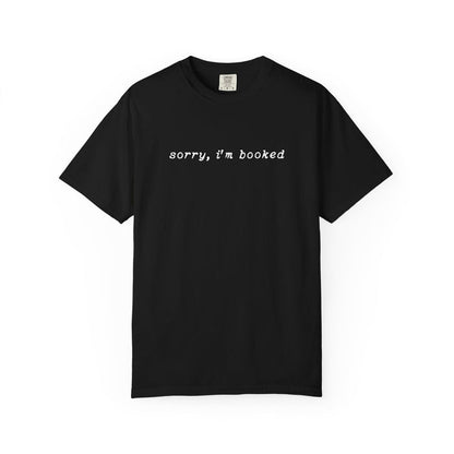 thtgrlreads black Comfort Colors graphic tee from the Book Bestie collection featuring a simple embroidered white script text "sorry, i'm booked" on a vintage wash unisex fit shirt.