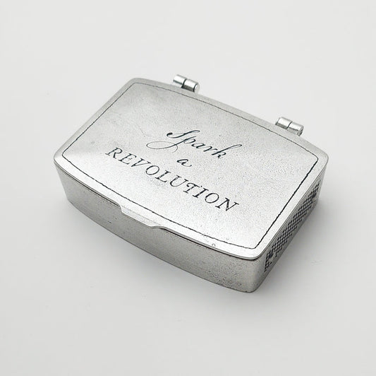 Metal matchbox tin with hinged lid, 'Spark Revolution' printed on top