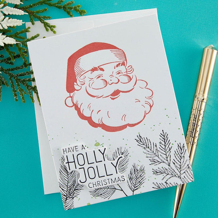 Spellbinders - Better Press Plates &amp; Die Set - Holly Jolly Santa. From the More BetterPress Christmas Collection with two press plates of a sweet and jolly Santa face and the perfect sentiment makes a great pair! Available at Embellish Away located in Bowmanville Ontario Canada. Example by brand ambassador.