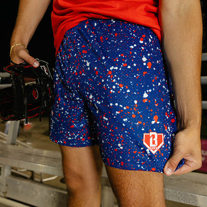 Adult model wearing red, white & blue Splatter USA shorts