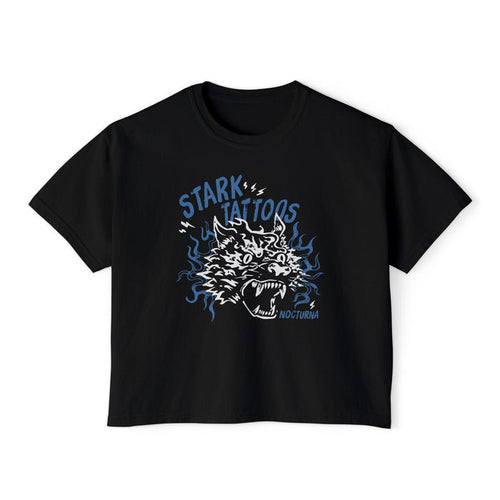 thtgrlreads Wolves of Ruin collection features a black Comfort Colors crop top with a vintage-style blue and white graphic of a roaring wolf head and "Stark Tattoos" text, offered by Printify in the Tees category.