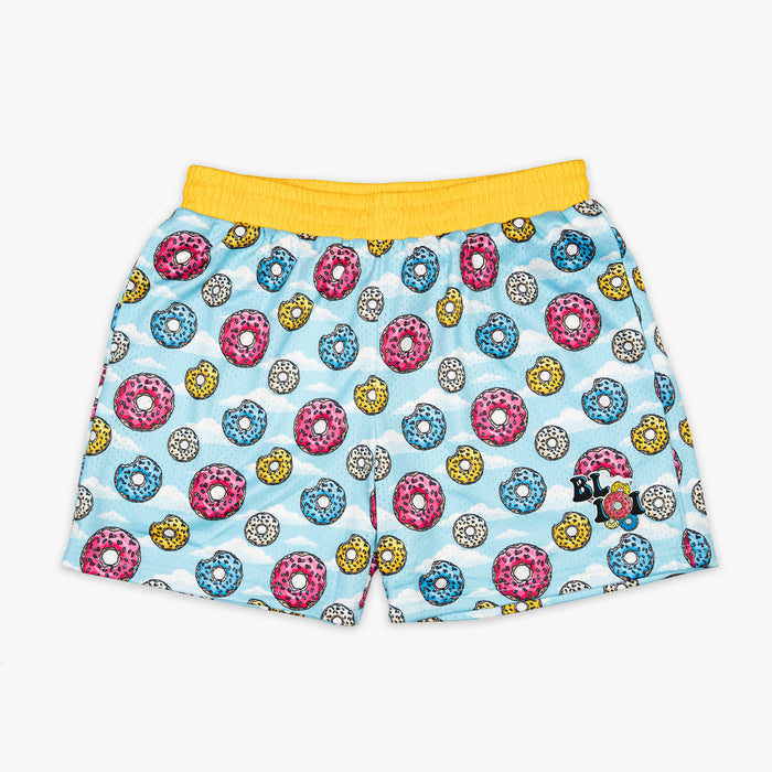 Youth model wearing multi-color youth shorts with “Sugar Rush Donut” design