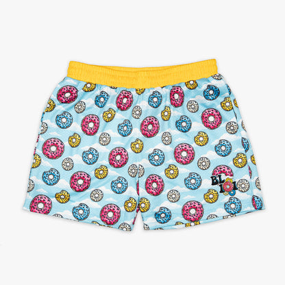 Youth model wearing multi-color youth shorts with “Sugar Rush Donut” design