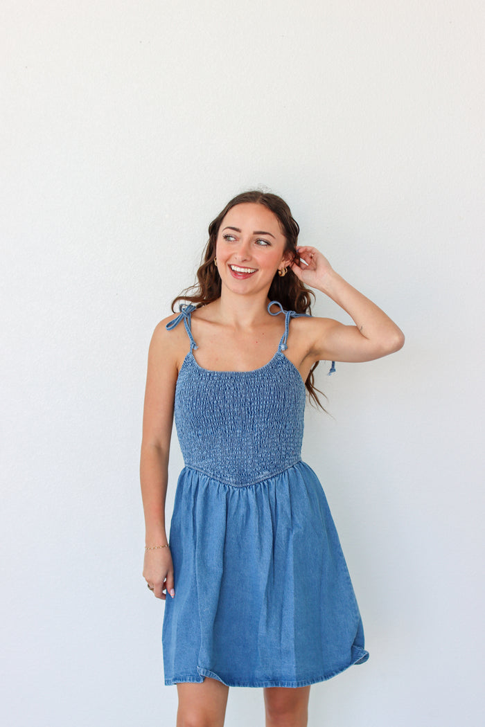 Woman wearing a blue dress against a white background