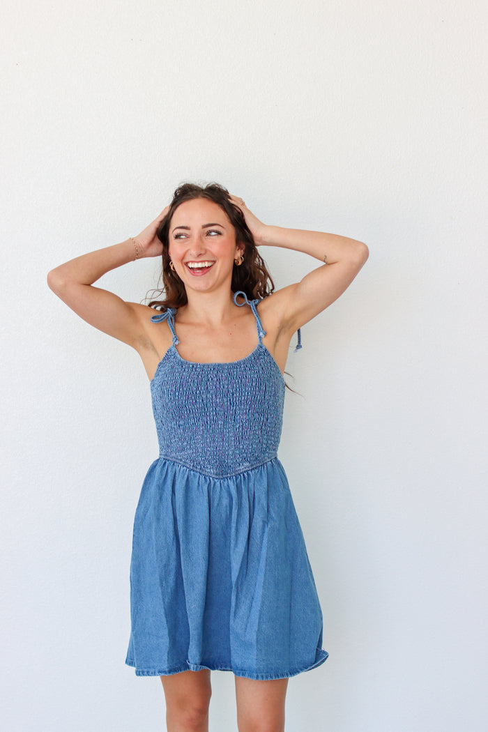 Woman wearing a blue dress against a white background