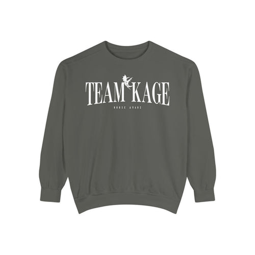 Bloodwing Academy crewneck sweatshirt from thtgrlreads featuring a vintage-wash, soft gray Comfort Colors fabric with bold white "TEAM KAGE" text and a small graphic print.
