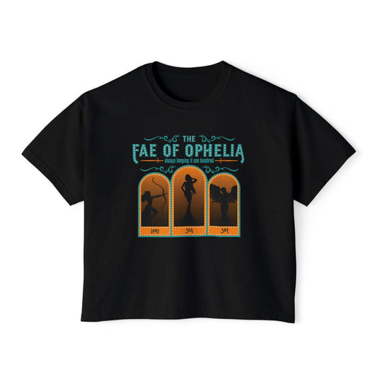 The Fae of Ophelia crop top from thtgrlreads features a vintage wash black Comfort Colors cotton fabric with a fantasy romance graphic in teal and orange, showcasing three silhouetted fae characters.