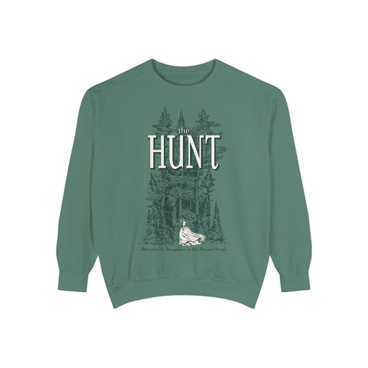 Thtgrlreads oversized crewneck from The Poison Daughter collection featuring vintage-wash green Comfort Colors fabric with a detailed graphic of a forest and a flowing-dress figure beneath "The Hunt" text in serif font.