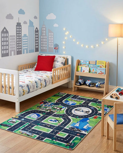 Green and blue rug featuring a city street map with roads and buildings, styled in a child's bedroom.