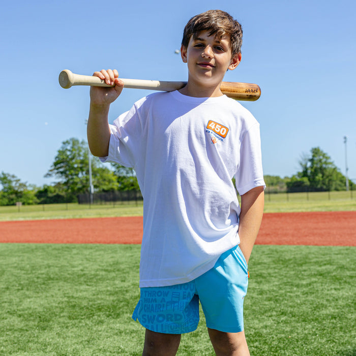 Youth model wearing blue youth shorts with "UVChangeup Trash Talk Youth" design