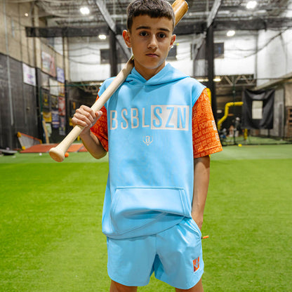 Youth model wearing blue youth shorts with "UVChangeup Trash Talk Youth" design