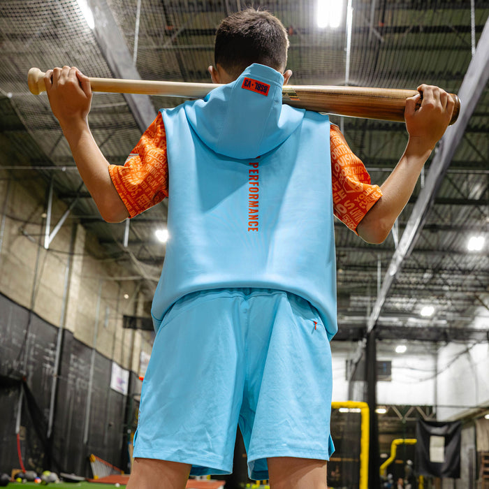Youth model wearing blue youth shorts with "UVChangeup Trash Talk Youth" design