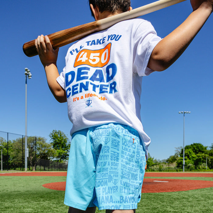 Youth model wearing blue youth shorts with "UVChangeup Trash Talk Youth" design