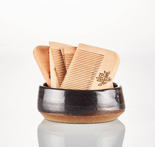 Wooden beard comb from The Immaculate Beard showing fine teeth and smooth finish for grooming facial hair.